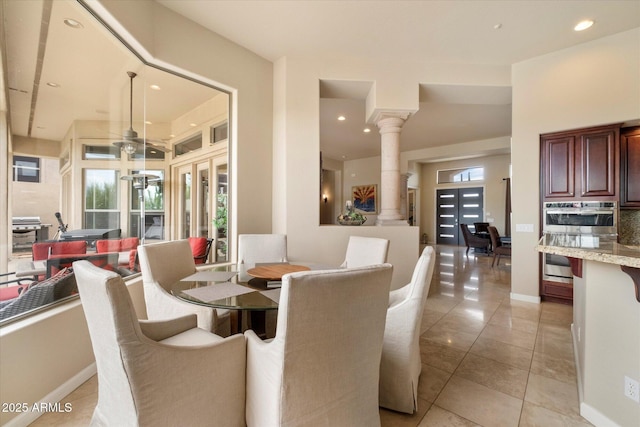 dining area featuring light tile patterned floors, recessed lighting, baseboards, and decorative columns