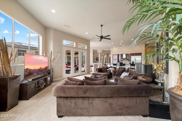 living room with light colored carpet, plenty of natural light, a ceiling fan, and recessed lighting