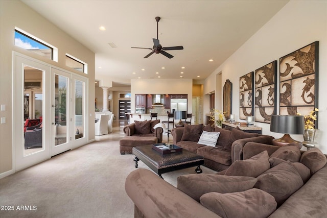 living room featuring recessed lighting, ornate columns, a ceiling fan, french doors, and light colored carpet