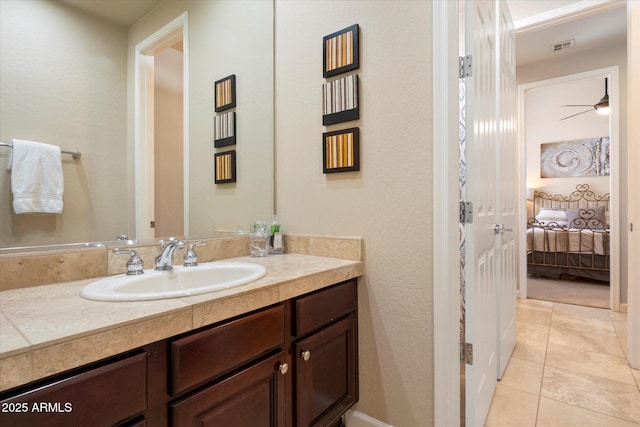 ensuite bathroom with ensuite bathroom, visible vents, a ceiling fan, tile patterned flooring, and vanity