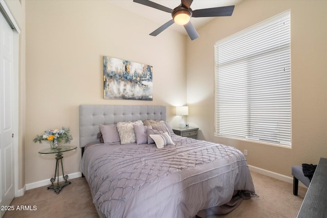 bedroom with a closet, carpet flooring, baseboards, and ceiling fan