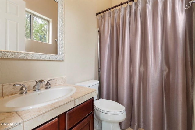 bathroom featuring vanity, a shower with shower curtain, and toilet