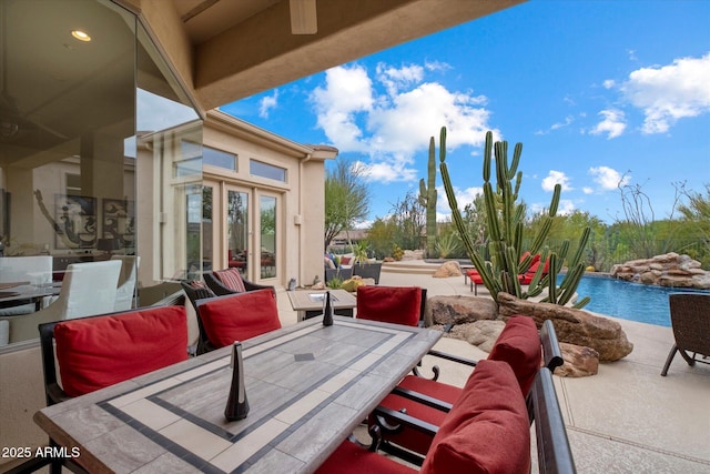 view of patio with an outdoor pool and outdoor dining area