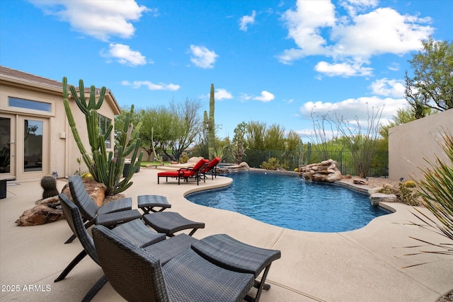 pool featuring a fenced backyard and a patio