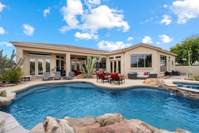 view of pool featuring outdoor lounge area, fence, a patio area, french doors, and a pool with connected hot tub