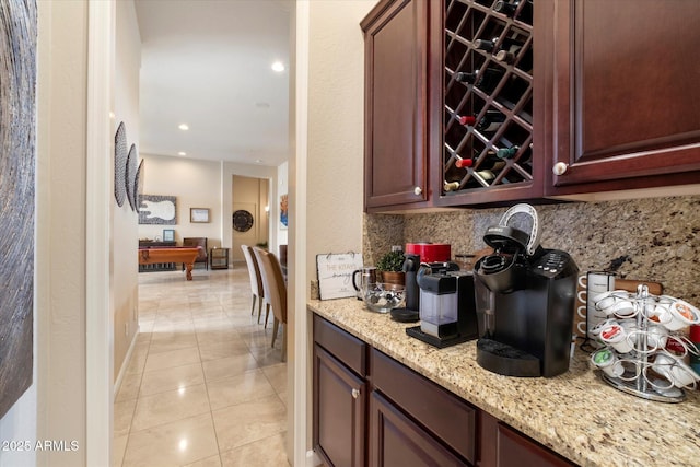 bar with tasteful backsplash, baseboards, and light tile patterned floors