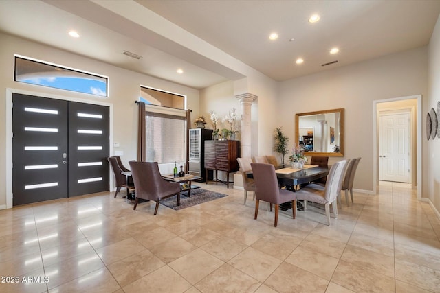 dining space featuring recessed lighting, visible vents, light tile patterned floors, and decorative columns