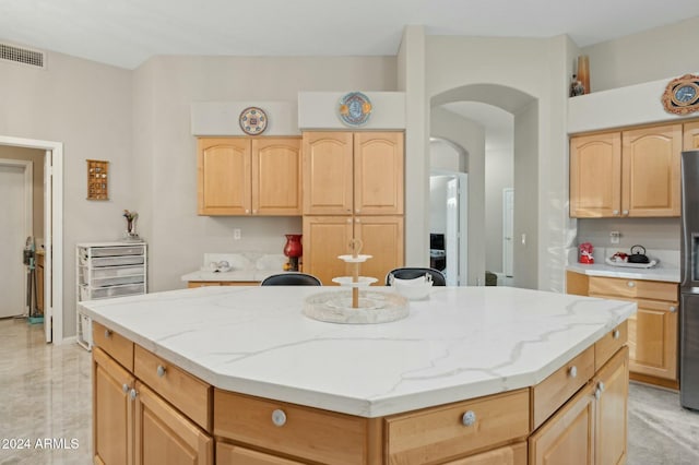 755 E Orchid Ln, Gilbert, AZ 85296 - kitchen featuring light brown cabinetry, a center island, and stainless steel refrigerator