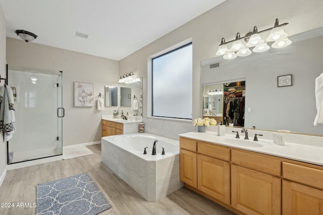755 E Orchid Ln, Gilbert, AZ 85296 - bathroom featuring wood-type flooring, vanity, and independent shower and bath
