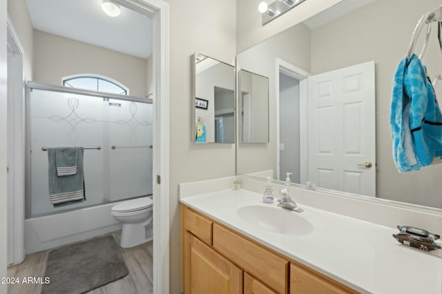 755 E Orchid Ln, Gilbert, AZ 85296 - full bathroom with shower / bath combination with glass door, wood-type flooring, vanity, and toilet