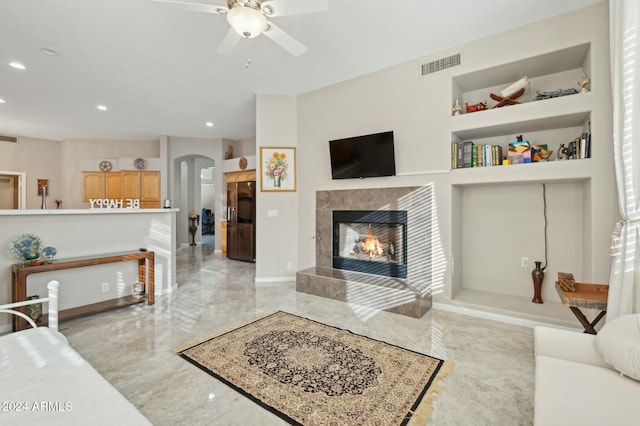 755 E Orchid Ln, Gilbert, AZ 85296 - living room with a tile fireplace, built in features, and ceiling fan