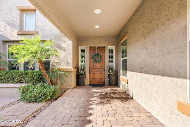 entrance to property with stucco siding