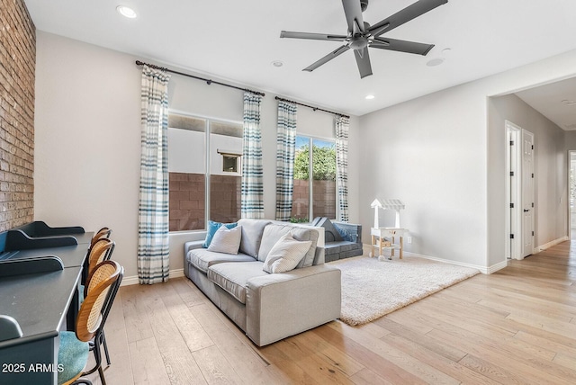 living room featuring wood-type flooring, recessed lighting, baseboards, and ceiling fan
