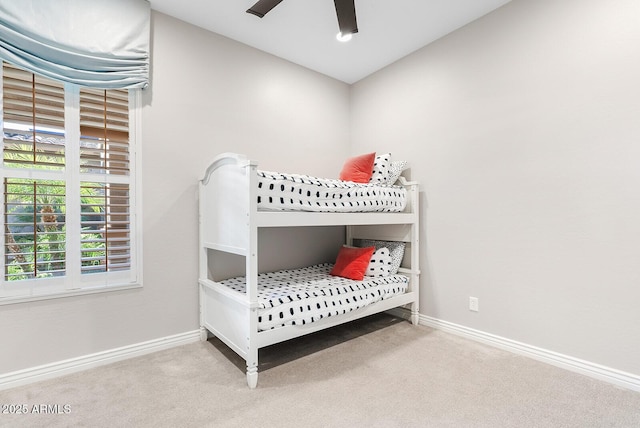 bedroom featuring carpet flooring, a ceiling fan, and baseboards