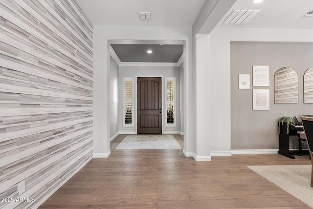 foyer entrance featuring visible vents, recessed lighting, baseboards, and wood finished floors