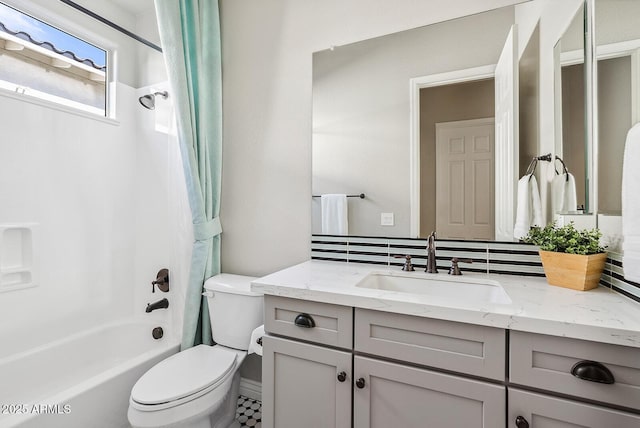 bathroom featuring toilet, shower / bath combo, and vanity