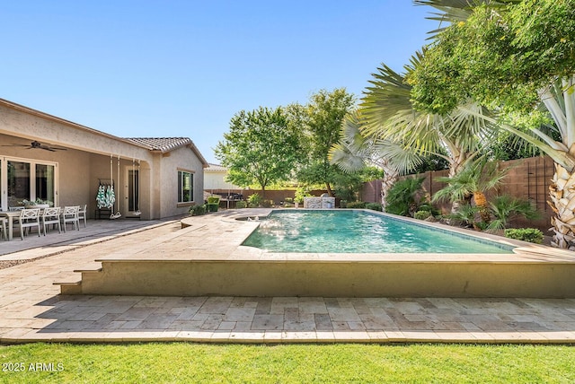 view of pool with a fenced in pool, a ceiling fan, a fenced backyard, and a patio area