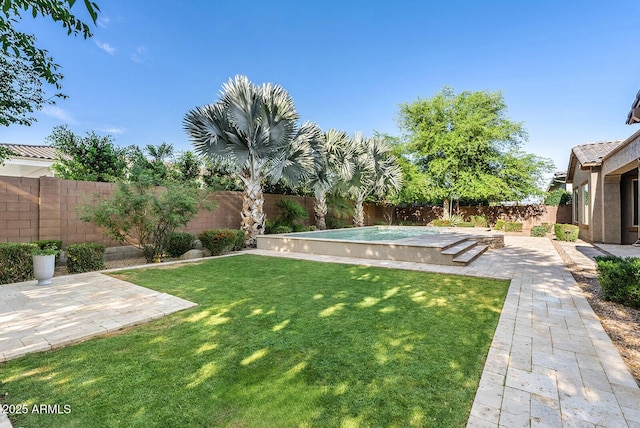 view of yard with a fenced in pool, a fenced backyard, and a patio area