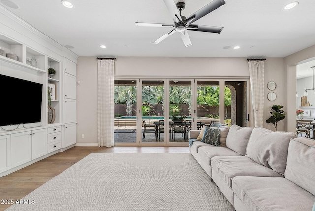living area featuring recessed lighting, baseboards, ceiling fan, and light wood-type flooring