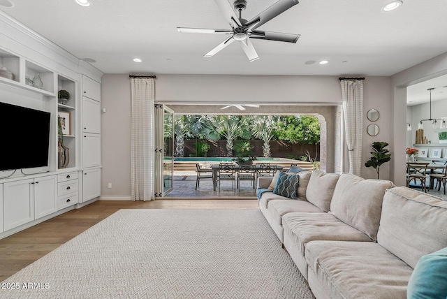 living area with light wood-style floors, recessed lighting, baseboards, and ceiling fan