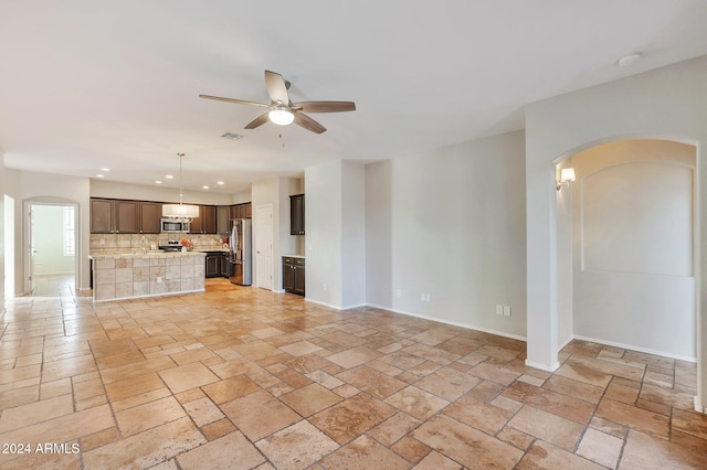 unfurnished living room featuring ceiling fan