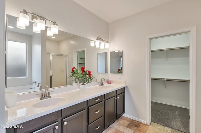 bathroom featuring separate shower and tub and vanity