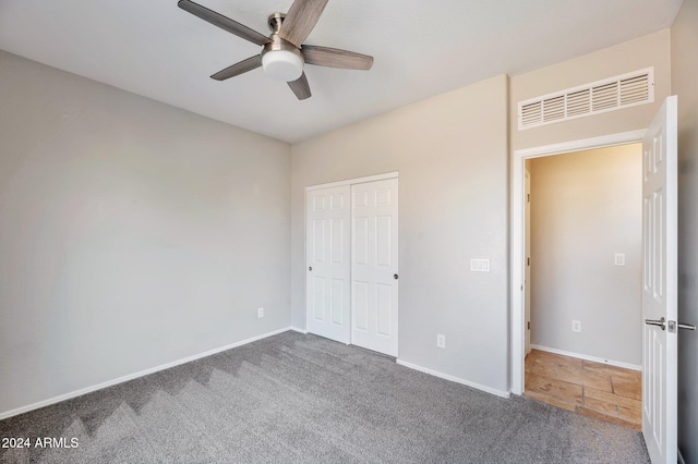 unfurnished bedroom featuring carpet flooring, ceiling fan, and a closet