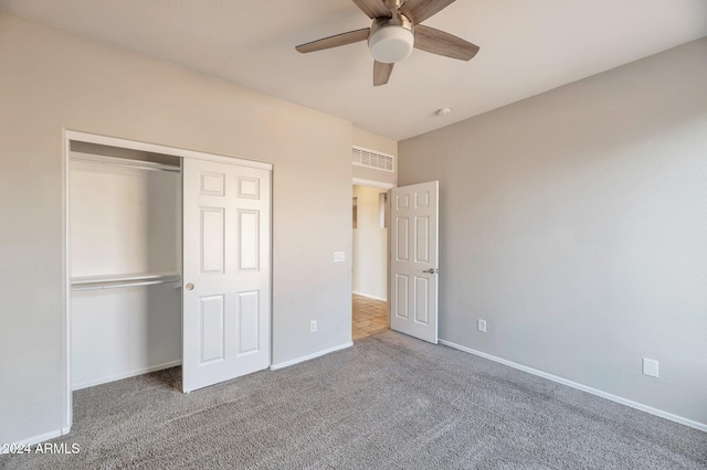 unfurnished bedroom featuring ceiling fan, carpet floors, and a closet