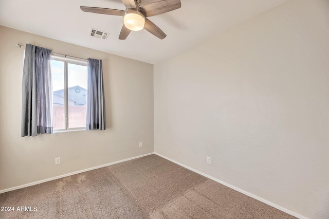 carpeted empty room featuring ceiling fan