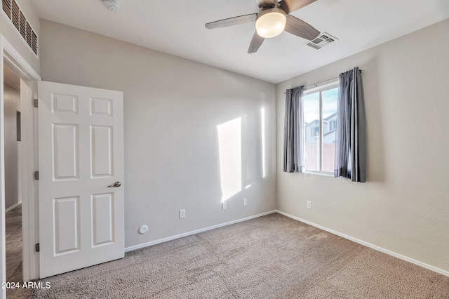 carpeted empty room with ceiling fan