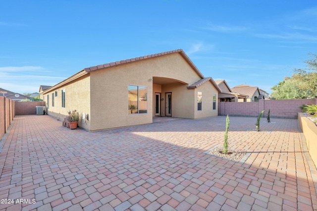 back of property featuring central AC unit and a patio