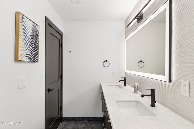 full bath featuring double vanity, tasteful backsplash, and baseboards