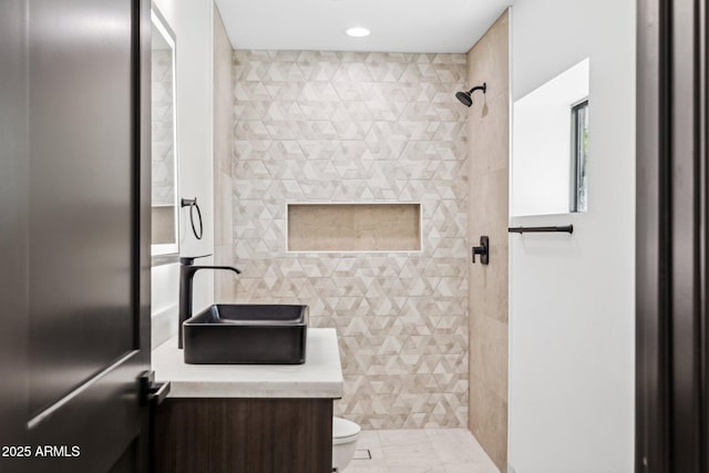 full bath with tile walls, toilet, a tile shower, vanity, and recessed lighting