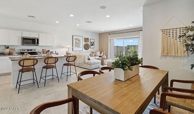 dining space featuring visible vents and recessed lighting