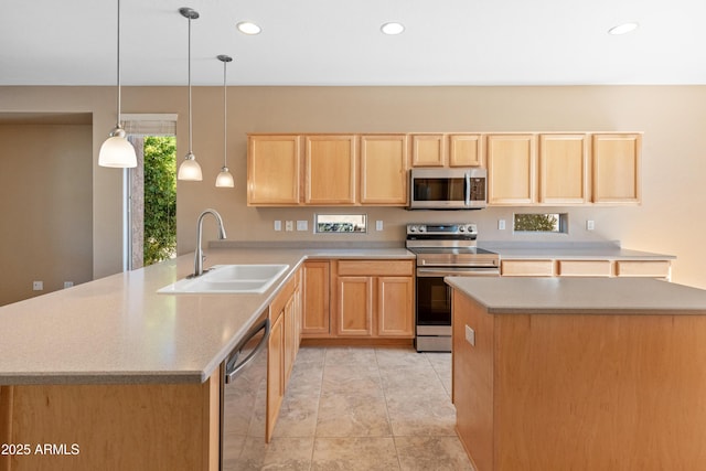 kitchen with sink, light brown cabinets, hanging light fixtures, and appliances with stainless steel finishes