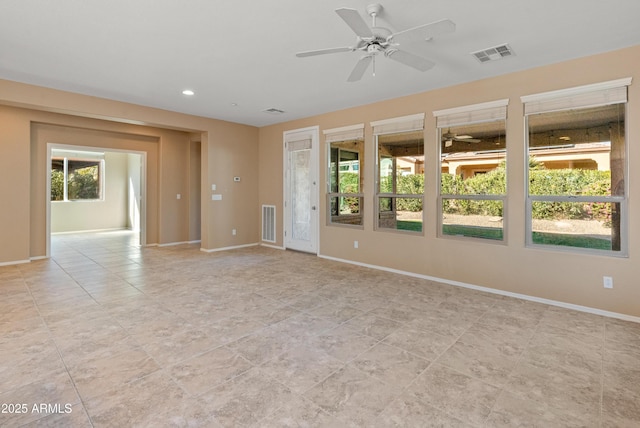 empty room featuring light tile patterned floors and ceiling fan