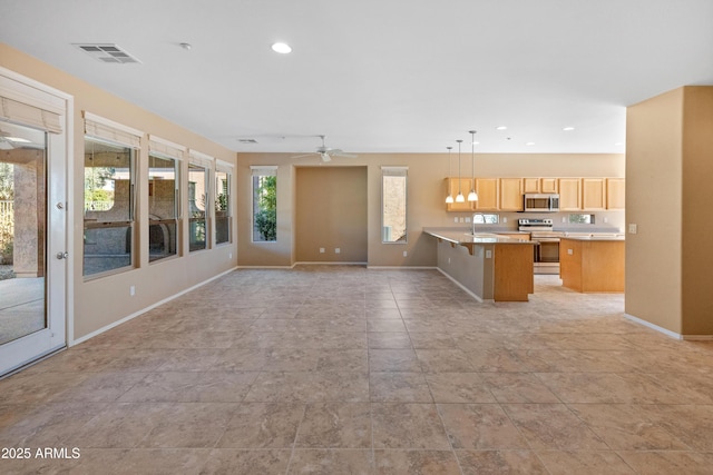 unfurnished living room featuring sink and ceiling fan