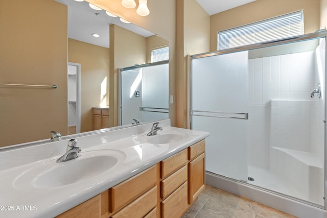 bathroom with vanity and a shower with door