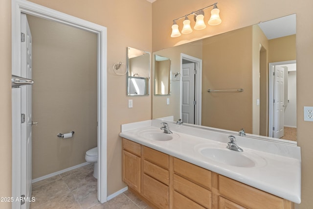 bathroom featuring vanity, tile patterned floors, and toilet