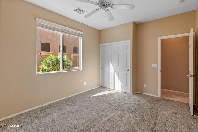 unfurnished bedroom with ceiling fan and carpet flooring