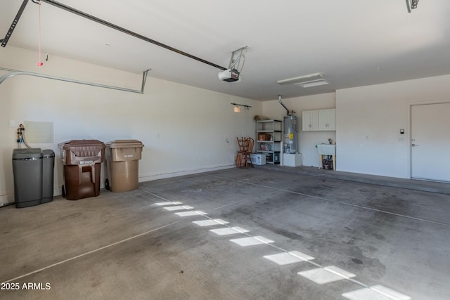 garage featuring a garage door opener, sink, and water heater