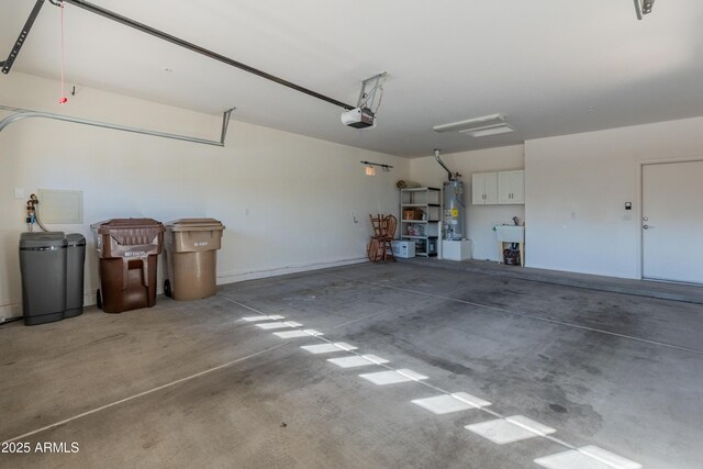 garage featuring sink, a garage door opener, and water heater