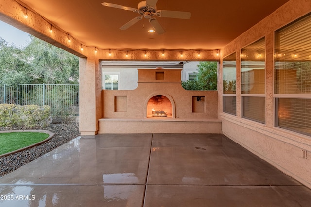 view of patio / terrace with an outdoor fireplace and ceiling fan