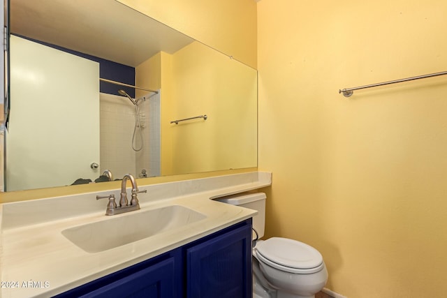 bathroom featuring vanity, toilet, and walk in shower