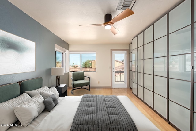 bedroom with ceiling fan and light wood-type flooring