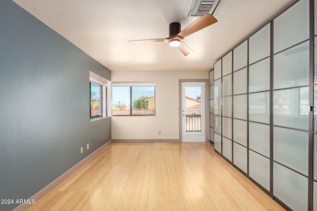 empty room featuring light hardwood / wood-style flooring and ceiling fan