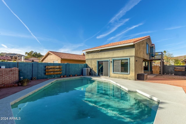 view of swimming pool with a patio area and central AC unit