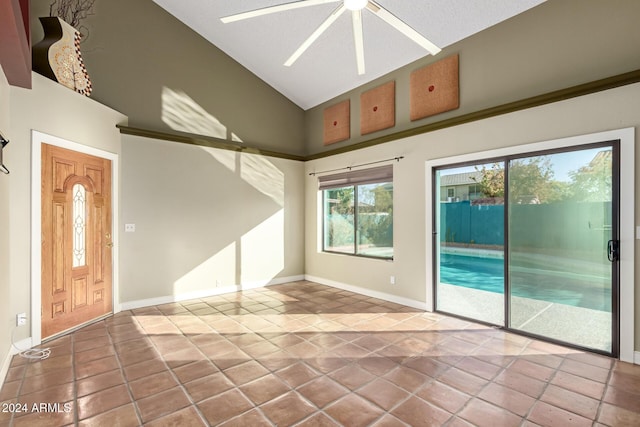 empty room featuring a textured ceiling and high vaulted ceiling