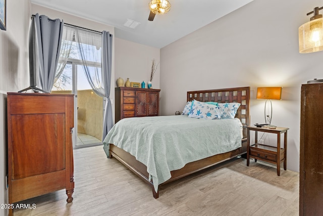 bedroom featuring visible vents, ceiling fan, and wood finished floors