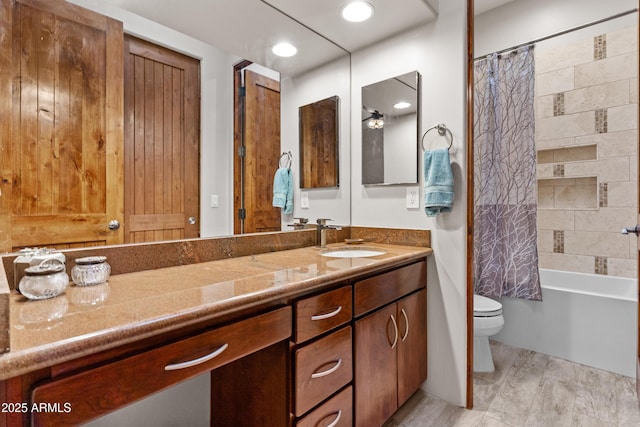 bathroom with vanity, toilet, wood finished floors, and shower / tub combo with curtain